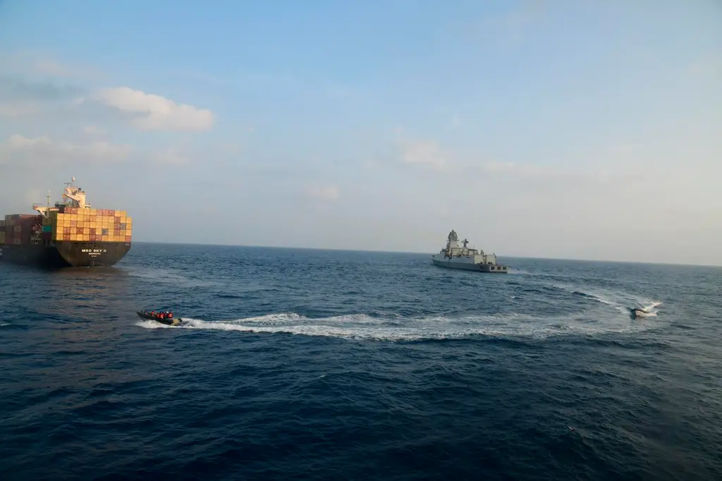 This photograph shared by Indian navy on the X platform shows a firefighting team from Indian Navy vessel INS Kolkata responding to a fire on Liberian-flagged Merchant ship MSC Sky II caused due to a suspected drone/missile attack in the Gulf of Aden, Tuesday, March 5, 2024. (Indian Navy on X via AP) , AP